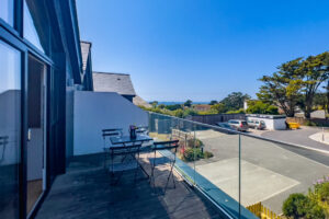 Balcony at the front of No 1 Treglos Gardens with seating and glass balustrades