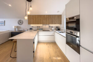 Open plan kitchen with integrated oven at No 1 Treglos Gardens