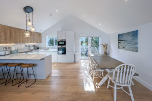 Open plan kitchen and dining area with ample seating at No 1 Treglos Gardens