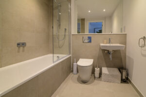Ground floor bathroom with bath, shower over, toilet and wash hand basin at Quiescence