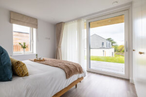 Master superking ensuite bedroom with wall length sliding door onto the patio at The Look Out