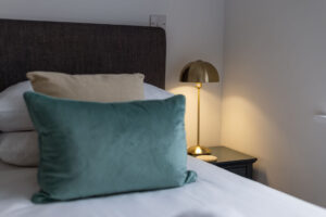 Cushions and bedside table and lamp in the second superking bedroom at The Look Out