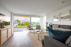 Lounge at The Look Out with seating and large wall length glass doors to the patio