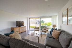 The lounge area at The Look Out with seating and tv and doors out to the patio