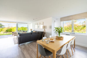 Open plan dining and lounge area at The Look Out with dining table and chairs
