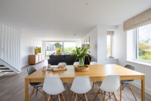 Dining table and chairs at The Look Out looking into the lounge area