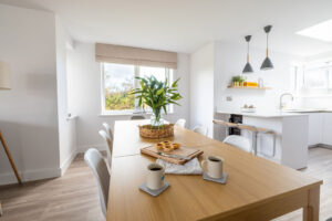 Open plan dining and kitchen area at The Look Out with dining table and chairs
