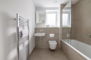 Bathroom off the hallway at The Look Out with shower over bath toilet and wash basin