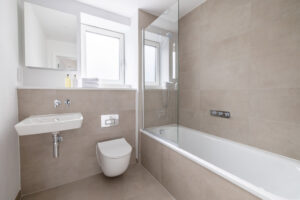 Bathroom off the hallway at The Look Out with shower over bath toilet and wash basin
