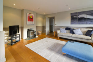 Lounge with log burner and TV at Coronado