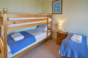 Bunk bed room with extra single bed on first floor at Coronado. The top bunk is only made up for guests if requested