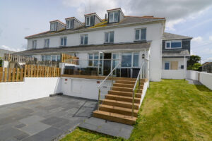 Rear exterior view of Coronado with steps from decking leading to lower garden area