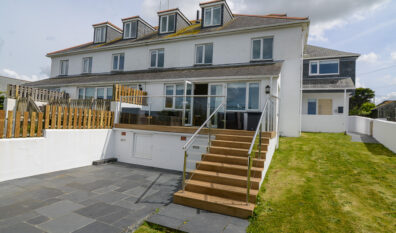 Rear exterior view of Coronado with steps from decking leading to lower garden area