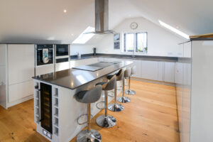 Well equipped kitchen with large island and bar stool seating at Morwynsow