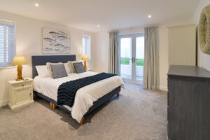 Ground floor king bedroom with double doors leading to the garden at Morwynsow