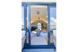 Balcony doors leading to open plan lounge and kitchen at Morwynsow