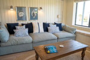the lounge in the open plan living area at Tremblze with comfortable sofa and coffee table and window to the front of the house
