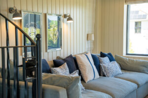 The sofa in the open plan living area with spiral staircase to the upstairs sitting room