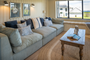 The sofa in the open plan living area with window seat and view to the front of Tremblaze