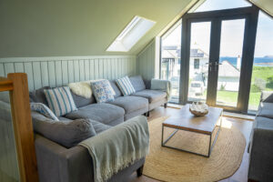 The second floor sitting room at Tremblaze with view toward the ocean from the double door onto the balcony