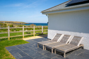 Wooden sun loungers on the rear patio at Tremblaze