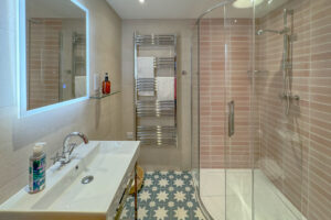 One of the two toilet and shower rooms on the ground floor at Tremblaze which has a shower cubicle, toilet and wash basin and is located just opposite the door to the king bedroom and also accessed through a door off the lobby