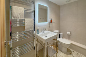 Bathroom of the ground floor lobby at Tremblaze with toilet, wash basin and there is also a large walk in shower in this bathroom