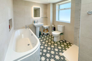 First floor bathroom with bath, toilet, shower and wash basin at Tremblaze