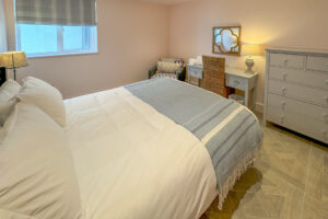 The ground floor king bedroom with dressing table, seating and chest of drawers at Tremblaze