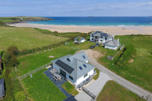 Aerial view over Tremblaze with Harlyn Bay beach and the ocean in the background