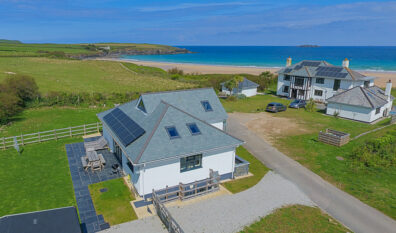 Aerial view over Tremblaze and a neighbouring property toward Harlyn Bay beach and over the ocean