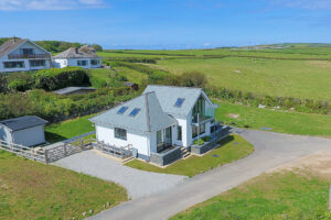 Aerial view toward the front of tremblaze with open fields and Trevose Head in the distance