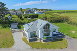 Aerial view over the front of Tremblaze with driveway to the rear garden to the side and neighbouring properties to the rear