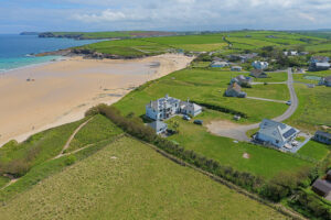 Aerial view over Harlyn Bay beach and the coastline and countryside in the background