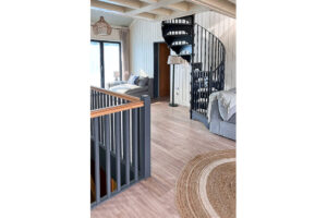 Staircase up from the ground floor into the living area at Tremblaze and spiral staircase up to the second floor sitting room