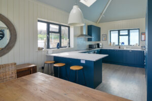 The kitchen area at Tremblaze from the dining area with windows to the side and rear of the house