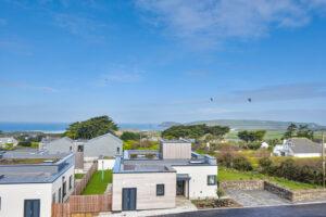 View over adjoining properties from the balcony to the ocean and Trevose Head