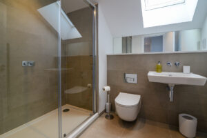 The ensuite room to the master king bedroom on the second floor with large shower cubicle, toilet and wash basin