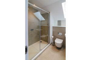 The ensuite room to the master king bedroom on the second floor with large shower cubicle, toilet and wash basin