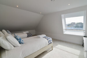 The second floor twin bedroom with window to the rear of the property