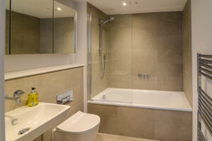 The first floor bathroom at The View which has a bath with shower over, toilet and wash basin