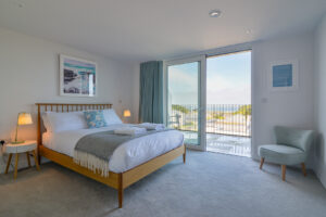 The first floor king bedroom with large sliding doors onto the balcony at The View