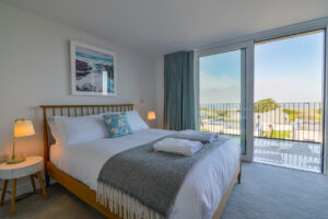 The first floor king bedroom with large sliding doors onto the balcony at The View