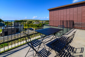 The outside dining table and chairs on the balcony at The View