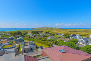 Aerial view over the golf course towards the ocean and Trevose Head from The View