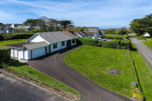 Exterior aerial view to front of house, front lawn and parking at Zefyros