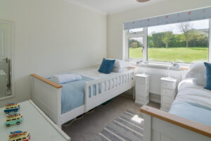 Twin bedroom to the rear of the house with large window to the rear garden as Zefyros