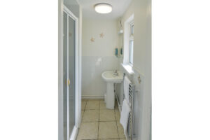 Ensuite shower room to the master king bedroom at Zefyros with shower cubicle, toilet and wash basin