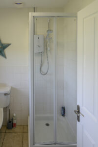 Shower room off the hallway to the left of the front entrance door at Zefyros with shower cubicle
