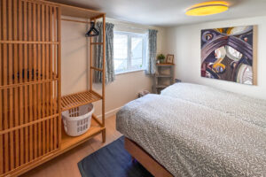 Twin beds with hanging space in bedroom 3 at No 8 Sandhills which can be made as a king bed if requested. The beds are small singles